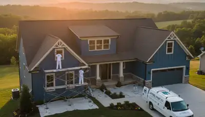 Professional house painters in Knoxville TN applying exterior paint to a residential home façade